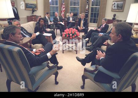 United States President George W. Bush meets with Prime Minister Tony Blair of Great Britain in the Oval Office of the White House in Washington, DC on Wednesday, November 7, 2001. Also visible in the photo are U.S. Secretary of State Colin Powell and National Security Advisor Condoleezza Rice.Mandatory Credit: Eric Draper - White House via CNP. Stock Photo