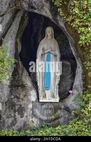 Lourdes, France - 9 Oct 2021: Statue of the Virgin Mary within the Massabielle Grotto in Lourdes Stock Photo