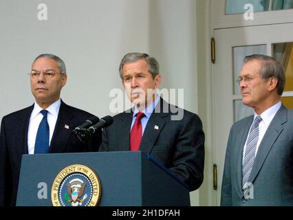 United States President George W. Bush announces his intention to withdraw the US from the 1972 ABM Treaty with the Russian Federation in the Rose Garden of the White House in Washington, DC on December 13, 2001. He called it a 'Cold War relic'. Left to right: US Secretary of State Colin Powell; President Bush; and US Secretary of Defense Donald Rumsfeld. Credit: Ron Sachs/CNP Stock Photo
