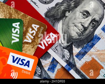 Kiev, Ukraine, April 7, 2020. Editorial illustrative. In this photoillustration is seen Visa credit cards and dollars in cash Stock Photo