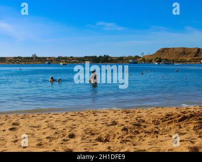 Sharm El Sheikh, Egypt - February 14, 2020: People resting at sand Beach Sharm El Maya in Egypt Stock Photo