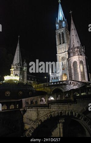 Lourdes, France - 9 Oct 2021: Pilgrims attend the Marian Torchlight Procession service at the Rosary Basilica in Lourdes Stock Photo