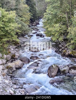 Cauterets, France - 10 Oct 2021: Waterfalls cascade from the Pyrenees mountains near La Raillere springs Stock Photo