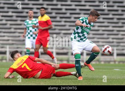 LAVRADIO, PORTUGAL - OCTOBER 16: Goncalo Franco of Moreirense FC competes for the ball with Bandeira of Oriental Dragon FC ,during the Portuguese Cup match between Oriental Dragon FC and Moreirense FC at Estadio Alfredo Da Silva on October 16, 2021 in Lavradio, Portugal. (MB Media) Stock Photo