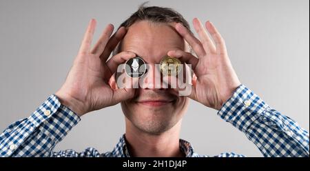 A man is holding a cryptocurrency.  Stock Photo