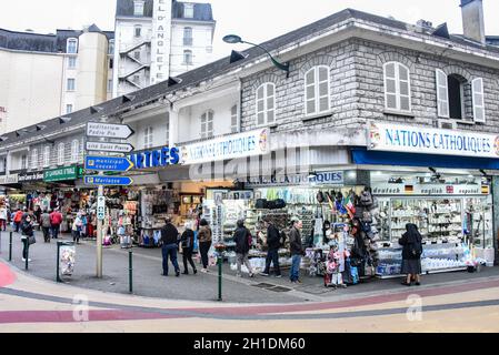 Lourdes, France - 10 Oct 2021: Tourist shops selling Catholic themed souvenirs to pilgirms near the Rosary Basilica in Lourdes Stock Photo