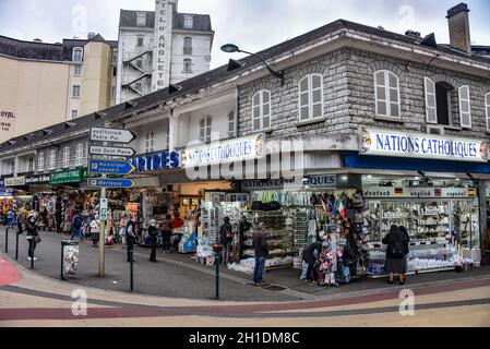 Lourdes, France - 10 Oct 2021: Tourist shops selling Catholic themed souvenirs to pilgirms near the Rosary Basilica in Lourdes Stock Photo