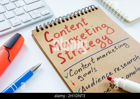 Handwritten Content marketing strategy and keyboard. Stock Photo