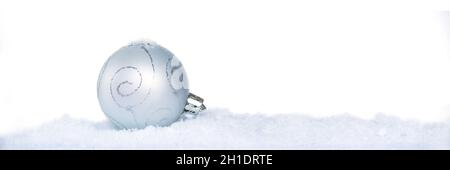 Close up of a white christmas ball with snow isolated on white background, holiday web banner Stock Photo