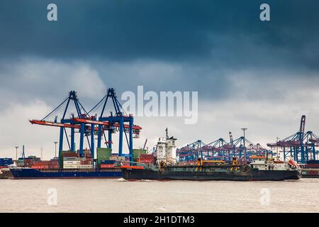 HAMBURG, GERMANY - MARCH, 2018: Industrial port cargo logistics containers and ship cranes in Hamburg Stock Photo