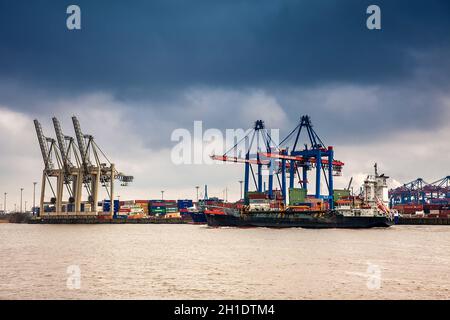 HAMBURG, GERMANY - MARCH, 2018: Industrial port cargo logistics containers and ship cranes in Hamburg Stock Photo