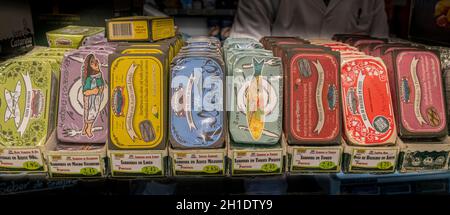 A row of various sardine tins for sale on a market stall Stock Photo