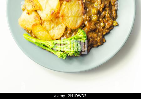 Minced beef hotpot, tender british beef in a warming gravy with carrots and peas, all topped with sliced roast potatoes, classic meal Stock Photo