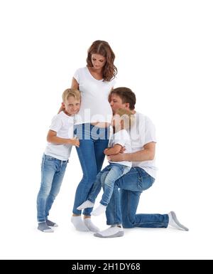 Friendly family. Husband with two sons are smiling and embracing pregnant woman, isolated on a white background.  Happy parents. Pregnant mother and f Stock Photo