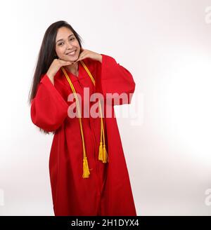 A pretty graduating student poses for the camera. Stock Photo