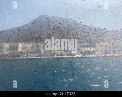 Melancholy coastal view seen through a window boat, Greece island, cyclades, Travel background Stock Photo