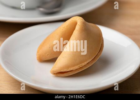 Single whole Chinese fortune cookie on a dish close up Stock Photo