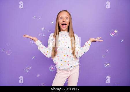 Photo of excited crazy little lady soap bubble fly open mouth wear dotted pajama isolated purple color background Stock Photo