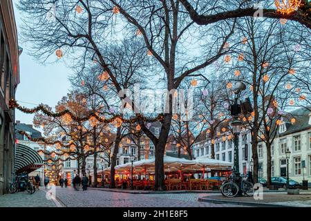 MAASTRICHT, THE NETHERLANDS - NOVEMBER 22, 2016: Dinner tables of bars and restaurants with christmas lights on the famous Onze Lieve Vrouweplein Stock Photo