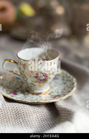 Porcelain tea pot and cup of hot tea on the table, antique traditional crockery set, high tea English afternoon tea Stock Photo
