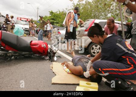 porto seguro, bahia / brazil - december 30, 2010: Samu rescuers service a motorcyclist involved in an accident on the BR 367 highway in Porto Seguro. Stock Photo