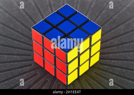 BUDAPEST, HUNGARY - CIRCA 2019: Solved Rubik's cube logic game on dark background evenly lit from all sides Stock Photo