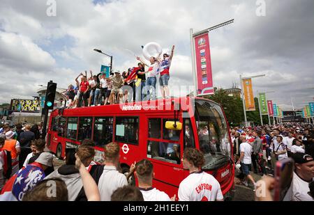 File photo dated 11-07-2021 of England fans climb aboard a bus outside the ground ahead of the UEFA Euro 2020 Final at Wembley Stadium, London. England have been ordered to play their next home UEFA competition match behind closed doors, with a further match suspended, in relation to the disorder at the Euro 2020 final at Wembley, UEFA has announced. Issue date: Monday October 18, 2021. Stock Photo