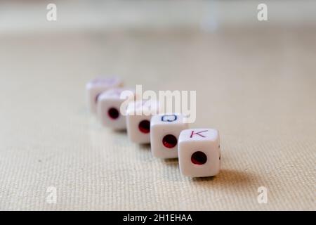 Row of five dice on white background with aces in the foreground Stock Photo