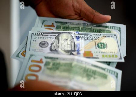 salvador, bahia / brazil - february 11, 2015: Hands hold dollar banknotes in currency exchange. *** Local Caption *** Stock Photo