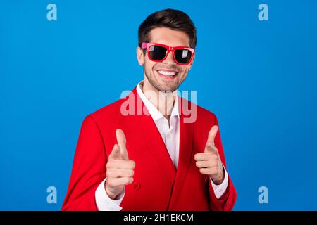 Photo of young cheerful man indicate fingers empty space banner direct ...