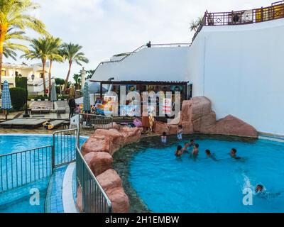 Sharm El Sheikh, Egypt - January 05, 2019: Tropical luxury Sultan Gardens Resort at Red Sea beach. Swimming pool , water slide and poolside seating ar Stock Photo