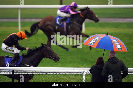 Patsy Fagan ridden by jokey Paul Hanagan (left) wins the Steve Lumb Quest For The Cheapest Pint Handicap with Dandy's Max ridden by jockey Joe Fanning second as spectators watch at Pontefract Racecourse, West Yorkshire. Picture date: Monday October 18, 2021. Stock Photo