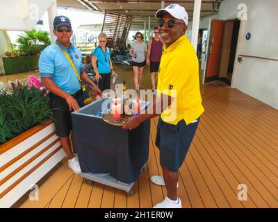 Cape Canaveral, USA - APRIL 29, 2018: The waiters with alcoholic and non-alcoholic drinks at luxury cruise ship Oasis of the Seas by Royal Caribbean. Stock Photo