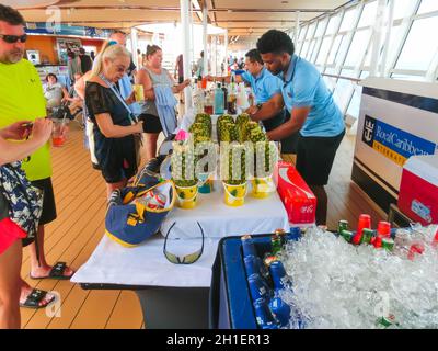 Cape Canaveral, USA - APRIL 29, 2018: The waiters with alcoholic and non-alcoholic drinks at luxury cruise ship Oasis of the Seas by Royal Caribbean. Stock Photo