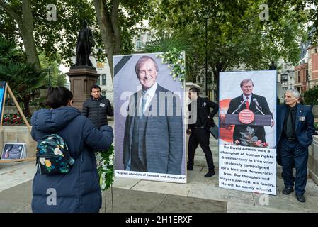 London, UK. 18th Oct, 2021. Members of the Anglo-Iranian community prepare to hold a service in Parliament Square in tribute to Sir David Amess, MP for Southend West, who was murdered on 15 October in his constituency surgery. Sir David was the co-chairman of the cross-party British Committee for Iran Freedom and for more than three decades championed for human rights and democracy in Iran. Later today, MPs will attend a service at St Margaret's Church in Westminster to pay tribute to their former colleague. Credit: Stephen Chung/Alamy Live News Stock Photo