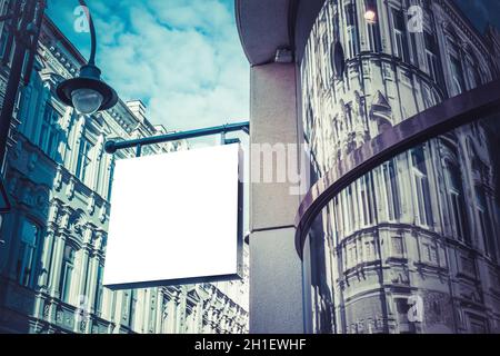 Mock up. Blank white rectangular shape signboard on the wall of classical architecture building. Signage of shop, store, cafe, restaurant Stock Photo