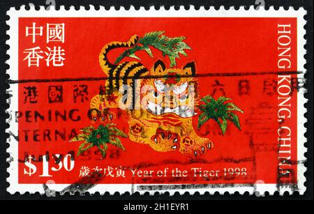 HONG KONG, CHINA - CIRCA 1998: a stamp printed in Hong Kong shows embroided design of tiger, year of the tiger, circa 1998 Stock Photo