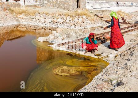 SAMBHAR, INDIA - NOVEMBER 19, 2012: Women mining salt at lake Sambhar, Rajasthan, India. Sambhar Salt Lake is India's largest inland salt lake Stock Photo