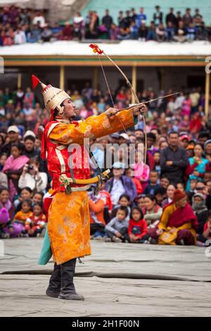 LEH, INDIA - SEPTEMBER 08, 2012: Dancers in traditional Ladakhi Tibetan costumes perform warlike dance at the Annual Festival of Ladakh Heritage in Le Stock Photo