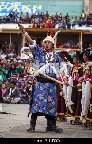LEH, INDIA - SEPTEMBER 08, 2012: Dancers in traditional Ladakhi Tibetan costumes perform warlike dance at the Annual Festival of Ladakh Heritage in Le Stock Photo