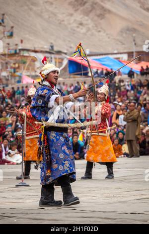 LEH, INDIA - SEPTEMBER 08, 2012: Dancers in traditional Ladakhi Tibetan costumes perform warlike dance at the Annual Festival of Ladakh Heritage in Le Stock Photo