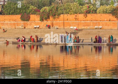 UJJAIN, INDIA - APRIL 25, 2011: People bathing and washing clothes in the morning on ghats of holy Kshipra river. Shipra is one of the sacred rivers i Stock Photo