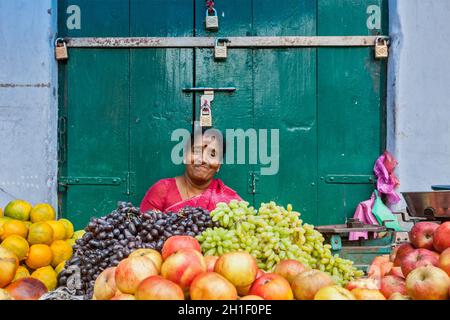 TIRUCHIRAPALLI, INDIA - FEBRUARY 14, 2013: Unidentified Indian woman - hawker (street vendor) of fruits Stock Photo
