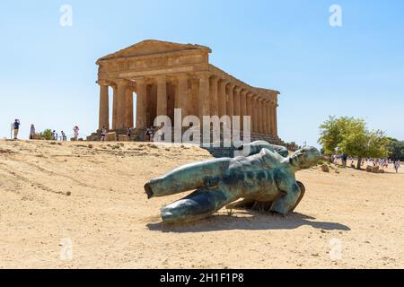 Agrigento, Italy - August 24, 2017: Sculpture of Icarus by Igor Mitoraj in front of the Concordia Temple in Valley of the Temples in Agrigento on Sici Stock Photo
