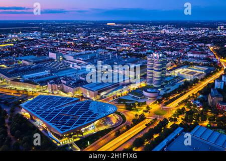 MUNICH, GERMANY - JULY 08, 2018: Aerial view of BMW Museum and BWM Welt and factory and Munich from Olympic Tower illuminated at night. BMW is a famou Stock Photo
