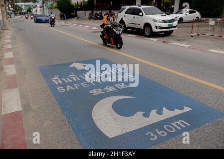 Patong, Thailand. 17th Oct, 2021. A tsunami safety zone sign on the road in Patong Beach. Thailand's Phuket Island has a 7 day quarantine period for vaccinated foreign tourists and locals, called the Phuket Sandbox. After a successful negative PCR test visitors are permitted to travel around the island during their quarantine. Thailand will allow fully vaccinated visitors from low-risk countries to enter the kingdom without quarantine from November 1 as a key effort by the government to boost the economy. Credit: SOPA Images Limited/Alamy Live News Stock Photo