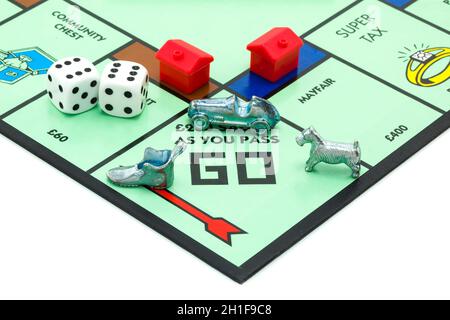 SWINDON, UK - JUNE 11, 2014: English Edition of Monopoly showing Pass Go,  The classic trading game from Parker Brothers was first introduced to Ameri Stock Photo