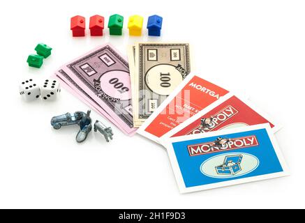 SWINDON, UK - JUNE 11, 2014: English Edition of Monopoly showing Money, Cards, Houses, Dice and Markers,  The classic trading game from Parker Brother Stock Photo