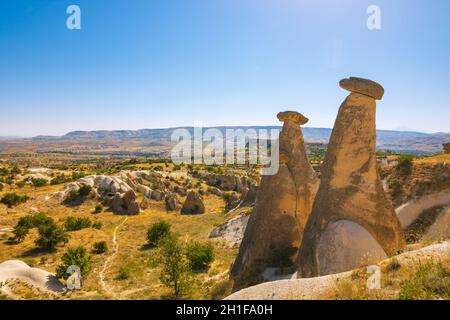 Three graces or Uc Guzeller in Turkish in Cappadocia Urgup Turkey. Beautiful fairy chimneys in Cappadocia. Landmarks of Turkey. Tourism day. Stock Photo