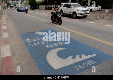 Patong, Thailand. 17th Oct, 2021. A tsunami safety zone sign on the road in Patong Beach. Thailand's Phuket Island has a 7 day quarantine period for vaccinated foreign tourists and locals, called the Phuket Sandbox. After a successful negative PCR test visitors are permitted to travel around the island during their quarantine. Thailand will allow fully vaccinated visitors from low-risk countries to enter the kingdom without quarantine from November 1 as a key effort by the government to boost the economy. (Photo by Paul Lakatos/SOPA Images/Sipa USA) Credit: Sipa USA/Alamy Live News Stock Photo